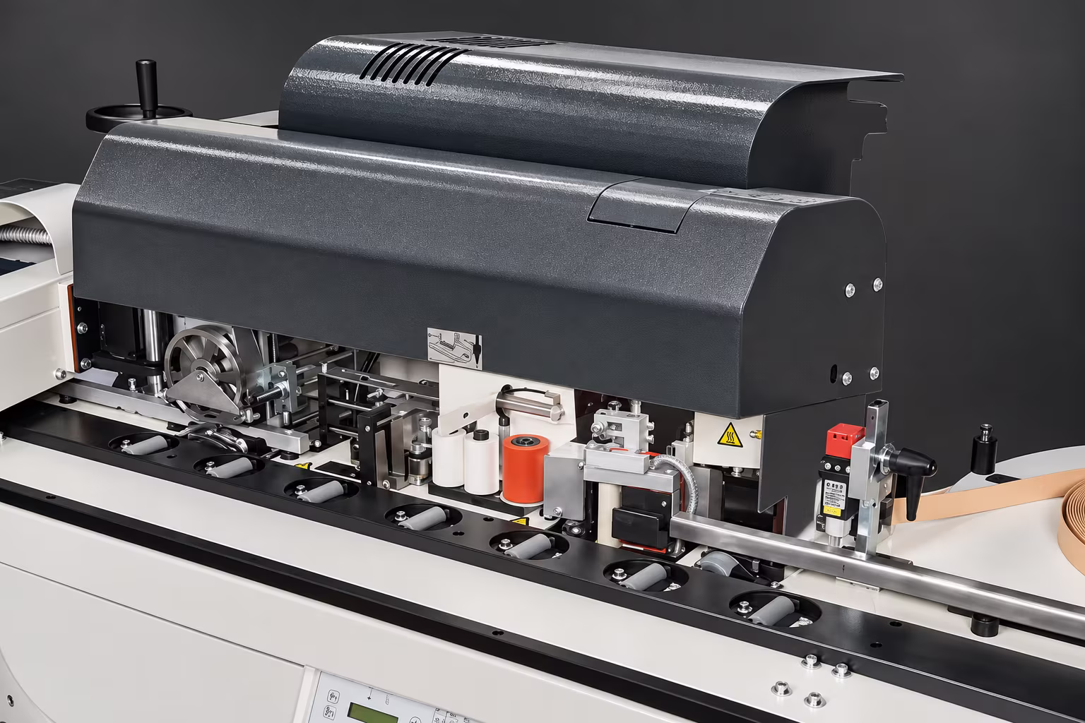 Working units under the hood: edge feed, glue roller, pressure rollers and end trimming